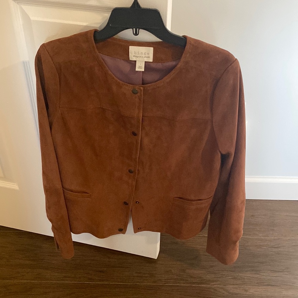 Brown suede jacket snaps down the front to front pockets. Never been worn.